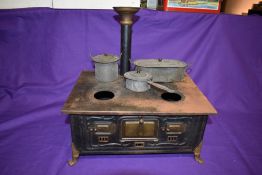 An early 20th century Marklin tin plate model of a Cooking Range on brass lion paw feet with