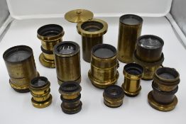 A selection of twelve brass lenses including 8 inch, Optimus etc