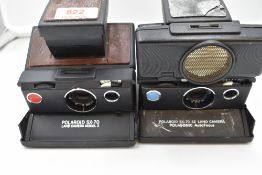 Two Polaroid cameras. An SX-70 Land Camera Palasonic Auto focus and a Model 2