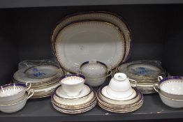 A part Aynsley Leighton dinner service having white ground with royal blue edge and gilt motif