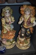 A pair of large figures or statuette by Capodimonte in a bisque finish standing at 68cm approx