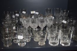 A selection of clear cut and crystal glass wares including wine and cocktail