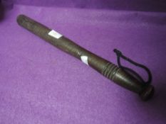 A wooden police style truncheon