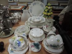 An assortment of ceramics including cups and saucers, platters,serving bowls and more.