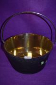 A well polished brass cast jam pan