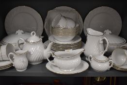 A part tea and dinner service by Harmony in a white and gilt design