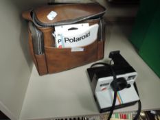 A vintage Polaroid land camera 1000 with red button, Polaroid case , warranty voucher for SX-70 film