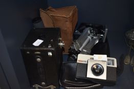 A vintage box camera, a Kodak instamatic 25 and a Velbon tripod.