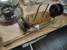 An assortment of antique fishing tackle including two wooden reels and an extending brass gaff
