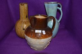 A 19th century salt glazed jug having moulded appliqué hunting scene, also include are two mid