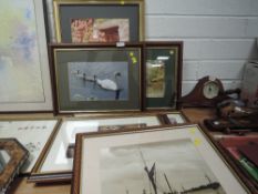 A collection of framed photographs, mixed subjects and sizes.
