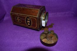 A vintage tea tin containing a collection of coins,various eras and currencies.