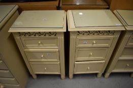 A pair of cream bedside cabinets