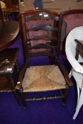 A rush seated low seat ladderback carver chair