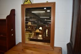 A modern pine wall mirror, approx. 56 x 71cm