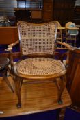 A traditional stained frame bergere armchair