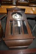 An early 20th Century oak wall clock case, with later quartz movement
