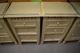 A pair of cream bedside cabinets