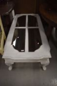 A modern painted coffee table, having smoked glass panels, approx137 x 67cm