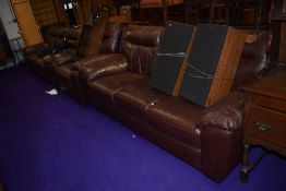 A modern brown leatherette or bycast lounge suite comprising two three seater settees and one chair