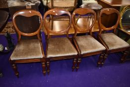 A set of four Victorian balloon back dining chairs