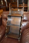 A traditional oak bookshelf/magazine rack, width approx. 35cm