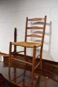 A traditional oak ladderback bedroom chair having strung seat
