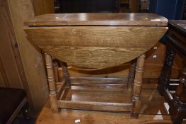 A light oak drop leaf occasional table , width approx. 64cm
