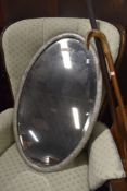 A reproduction pewter effect oval wall mirror