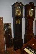 An early to late 20th Century reproduction oak long case clock having moon dial, triple weight