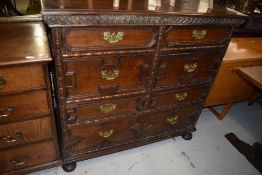 A 19th Century Jacobean style cushion chest of seven drawers, in side by side configuration over