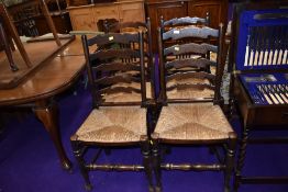 A traditional oak framed set of four rush seated ladderback chairs