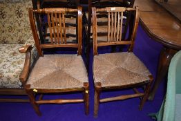 A pair of 19th Century rush seated rail back chairs