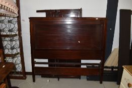 A late 20th Century mahogany pannelled bed frame including side irons and base, approx width 137cm