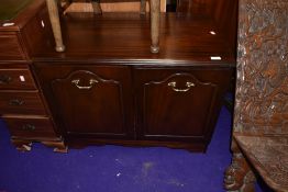 A mahogany effect low cupboard
