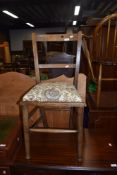 A traditional stained frame bedroom chair with upholstered seat