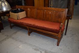 A golden oak pew/form having 6 panel back, width approx. 210cm