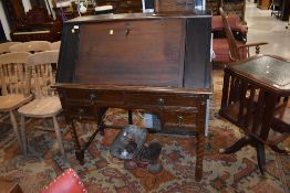 A composite desk on stand, top converted corner cupboard on Jacobean style base with twist legs
