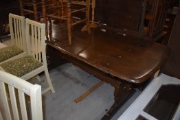 A vintage dark stained Ercol dining table, length approx. 183cm