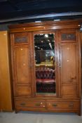 A Victorian mahogany double wardrobe having ash drawers dentil cornice over mirrored centre panel