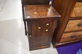 A traditional dark oak bedside pot cupboard, height approx. 75cm