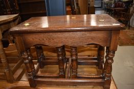 A traditional oak nest of one large over two small tables, large approx. 62 x 37cm