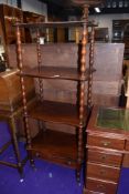 A Victorian mahogany whatnot etage, having four shaped tiers and drawer to base