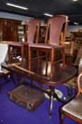 A modern mahogany effect reproduction Regency style dining table and four chairs having