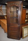 A mid to late 20th Century oak corner display cabinet with enclosed cupboard base, height approx.
