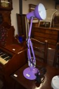 A modern lilac angle poise lamp