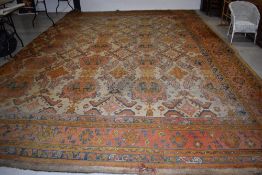 A large antique carpet square, labelled for Gillows, Lancaster, approx. 400 x 580cm