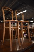 A pair of stripped bentwood high seat chairs