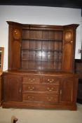 A traditional oak dresser having delft rack flanker by two corner style cupboards over drawer and