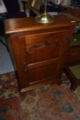A reproduction oak shallow cupboard, dimensions approx. W57cm D24cm H84cm